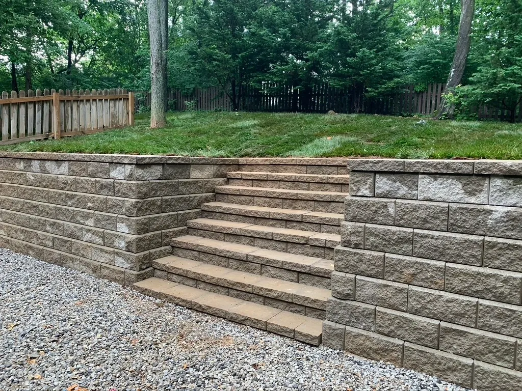 A stone wall with steps leading to the top of it.